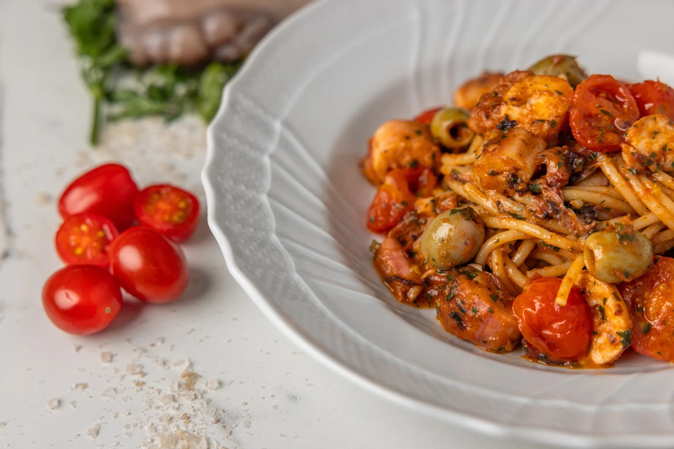 Spaghetti alla Luciana — bronze-drawn spaghettoni with slow-cooked octopus, taggiasche olives and datterini tomatoes